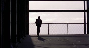 Movie still from “The Natural” (1984), directed by Barry Levinson – A man in a suit and top hat walking down a ramp; Extreme Wide shot, Low angle