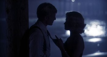 Movie still from “The Natural” (1984), directed by Barry Levinson – A man and a woman talking in the dark at night; Close Up shot, Over the shoulder angle