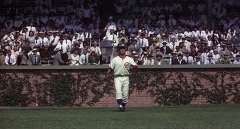 Movie still from “The Natural” (1984), directed by Barry Levinson – A baseball player in the outfield during a baseball game; Wide shot, Low angle