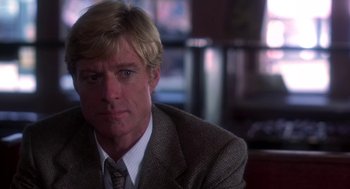 Movie still from “The Natural” (1984), directed by Barry Levinson – A person wearing a suit and tie; Close Up shot, Over the shoulder angle