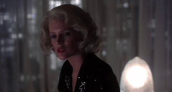 Movie still from “The Natural” (1984), directed by Barry Levinson – A woman with blonde hair wearing a sequined shirt; Close Up shot, Low angle