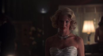 Movie still from “The Natural” (1984), directed by Barry Levinson – A woman in a strapless white dress with a diamond necklace; Close Up shot, Low angle