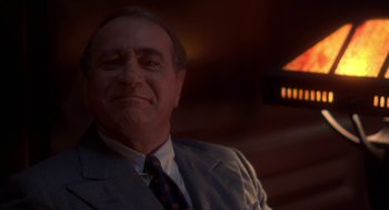 Movie still from “The Natural” (1984), directed by Barry Levinson – An older man wearing a suit and tie; Close Up shot, Low angle