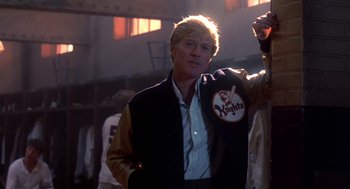 Movie still from “The Natural” (1984), directed by Barry Levinson – Robert redford wearing a baseball jacket; Medium shot, Low angle