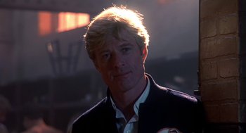 Movie still from “The Natural” (1984), directed by Barry Levinson – A person wearing a suit and tie; Close Up shot, Low angle