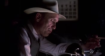 Movie still from “The Natural” (1984), directed by Barry Levinson – A man wearing a hat and a striped shirt; Close Up shot, Low angle