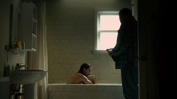 Movie still from “Charlie Countryman” (2013), directed by Fredrik Bond – A man in a bath tub next to another man in a bath tub; Medium shot, Over the shoulder angle
