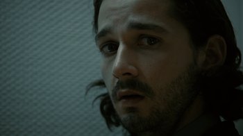 Movie still from “Charlie Countryman” (2013), directed by Fredrik Bond – A person with long hair; Close Up shot, High angle