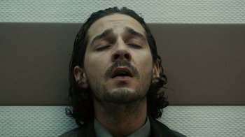 Movie still from “Charlie Countryman” (2013), directed by Fredrik Bond – A person with long black hair; Close Up shot, Low angle