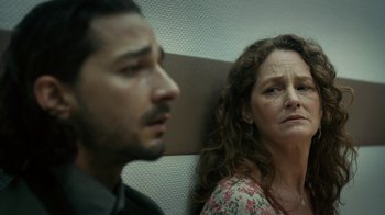 Movie still from “Charlie Countryman” (2013), directed by Fredrik Bond – A man and a woman sitting next to each other on a train; Close Up shot, Low angle