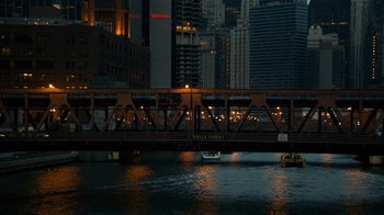 Movie still from “Charlie Countryman” (2013), directed by Fredrik Bond – A boat traveling across a bridge in a city at night; Extreme Wide shot, High angle
