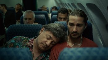 Movie still from “Charlie Countryman” (2013), directed by Fredrik Bond – A man and a woman sleeping on a plane; Medium shot, High angle