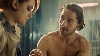 Movie still from “Charlie Countryman” (2013), directed by Fredrik Bond – A man and a woman looking in the same mirror; Close Up shot, Over the shoulder angle