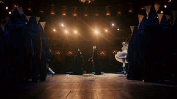 Movie still from “Charlie Countryman” (2013), directed by Fredrik Bond – A group of people on a stage performing a dance; Extreme Wide shot, Low angle