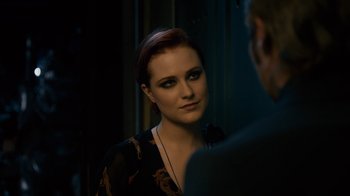Movie still from “Charlie Countryman” (2013), directed by Fredrik Bond – A woman looking into a mirror while standing next to a man; Close Up shot, Over the shoulder angle