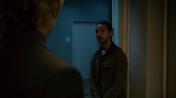 Movie still from “Charlie Countryman” (2013), directed by Fredrik Bond – A man standing in front of a mirror looking at himself in the mirror; Medium shot, Over the shoulder angle