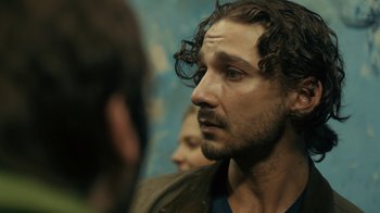 Movie still from “Charlie Countryman” (2013), directed by Fredrik Bond – A person with curly hair; Close Up shot, Over the shoulder angle