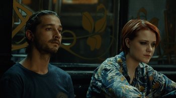 Movie still from “Charlie Countryman” (2013), directed by Fredrik Bond – A man and a woman sitting next to each other on a bus; Close Up shot, Over the shoulder angle
