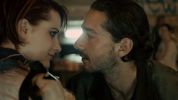 Movie still from “Charlie Countryman” (2013), directed by Fredrik Bond – A man and a woman looking at one another; Close Up shot, Over the shoulder angle