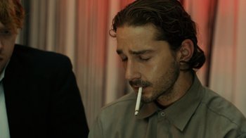Movie still from “Charlie Countryman” (2013), directed by Fredrik Bond – A person with a cigarette in his mouth; Close Up shot, Over the shoulder angle
