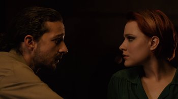Movie still from “Charlie Countryman” (2013), directed by Fredrik Bond – A man and a woman face to face in a dark room; Close Up shot, Low angle