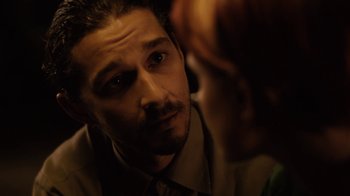 Movie still from “Charlie Countryman” (2013), directed by Fredrik Bond – A person wearing a suit and tie; Close Up shot, Over the shoulder angle