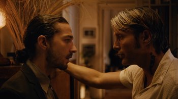Movie still from “Charlie Countryman” (2013), directed by Fredrik Bond – A man and a woman face each other in a room; Close Up shot, Low angle