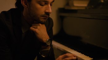 Movie still from “Charlie Countryman” (2013), directed by Fredrik Bond – A person sitting at a piano; Close Up shot, High angle
