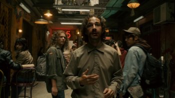 Movie still from “Charlie Countryman” (2013), directed by Fredrik Bond – A group of people standing in a room; Medium shot, Low angle