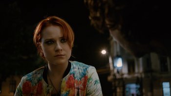 Movie still from “Charlie Countryman” (2013), directed by Fredrik Bond – A beautiful young lady with red hair wearing a floral jacket; Close Up shot, Over the shoulder angle
