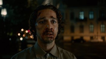 Movie still from “Charlie Countryman” (2013), directed by Fredrik Bond – A person with blood all over his face; Close Up shot, Low angle
