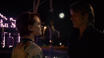 Movie still from “Charlie Countryman” (2013), directed by Fredrik Bond – A man and a woman standing next to each other; Medium shot, Low angle
