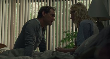 Movie still from “The Nest” (2020), directed by Sean Durkin – A man and a woman talking on a bed in a room; Medium shot, Over the shoulder angle