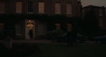 Movie still from “The Nest” (2020), directed by Sean Durkin – Two people walking in front of a building at night; Extreme Wide shot, Over the shoulder angle