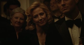 Movie still from “The Nest” (2020), directed by Sean Durkin – A person wearing a suit and tie; Close Up shot, Over the shoulder angle