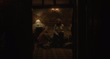 Movie still from “The Nest” (2020), directed by Sean Durkin – A woman sitting on a couch in a living room; Wide shot, High angle