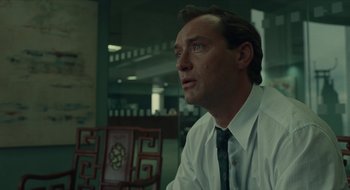 Movie still from “The Nest” (2020), directed by Sean Durkin – A person sitting at a table wearing a shirt and tie; Close Up shot, Low angle