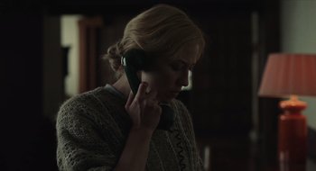 Movie still from “The Nest” (2020), directed by Sean Durkin – A woman holding a cell phone up to her ear; Close Up shot, Low angle