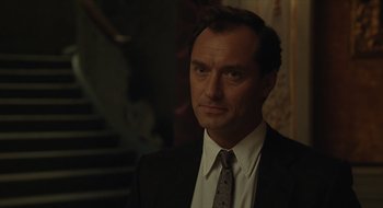Movie still from “The Nest” (2020), directed by Sean Durkin – A person wearing a suit and tie; Close Up shot, Over the shoulder angle
