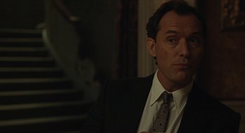 Movie still from “The Nest” (2020), directed by Sean Durkin – A person wearing a suit and tie; Close Up shot, Over the shoulder angle