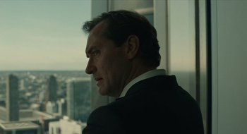 Movie still from “The Nest” (2020), directed by Sean Durkin – A person wearing a suit looking out of a window; Close Up shot, Over the shoulder angle