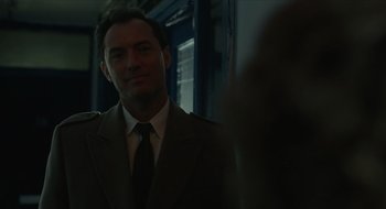 Movie still from “The Nest” (2020), directed by Sean Durkin – A man wearing a suit and tie standing in front of a window; Close Up shot, Over the shoulder angle