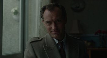 Movie still from “The Nest” (2020), directed by Sean Durkin – A person wearing a suit and tie; Close Up shot, Low angle