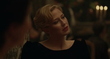 Movie still from “The Nest” (2020), directed by Sean Durkin – A woman with blonde hair wearing a black dress; Close Up shot, Over the shoulder angle