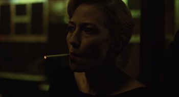 Movie still from “The Nest” (2020), directed by Sean Durkin – A woman is smoking a cigarette in the dark; Close Up shot, Over the shoulder angle
