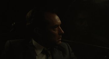 Movie still from “The Nest” (2020), directed by Sean Durkin – A man in a suit and tie looking to his left; Close Up shot, Over the shoulder angle