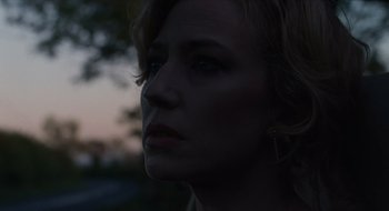 Movie still from “The Nest” (2020), directed by Sean Durkin – A woman's face in the dark; Close Up shot, Low angle