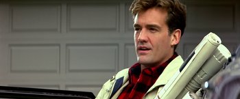 Movie still from “The NeverEnding Story II: The Next Chapter” (1990), directed by George Miller – A person wearing a jacket and a scarf; Close Up shot, Over the shoulder angle