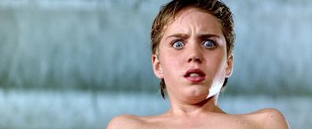 Movie still from “The NeverEnding Story II: The Next Chapter” (1990), directed by George Miller – A young girl with blue eyes is taking a shower; Close Up shot, Low angle