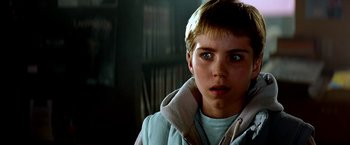 Movie still from “The NeverEnding Story II: The Next Chapter” (1990), directed by George Miller – A young boy is looking into the distance; Close Up shot, Low angle